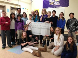 Joey Temali (far left) with the students at ISLA in Minnetonka being presented a check to help build a school in Bolivia!