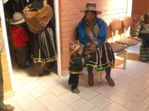 Mother and child waiting to be seen at the Mano a Mano clinic in Confital, a community in the department of Cochabamba