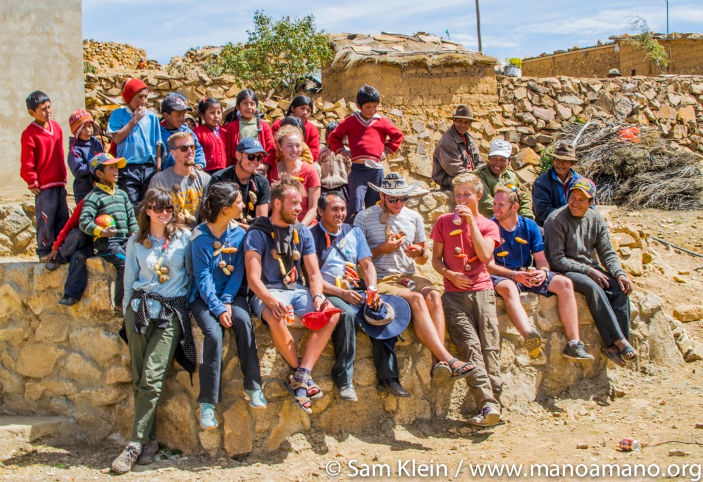 Rural Bolivians celebrate with Oxford University volunteers. New greenhouses mean a drastic change for the children in these families, who will grow stronger with a more reliable diet.