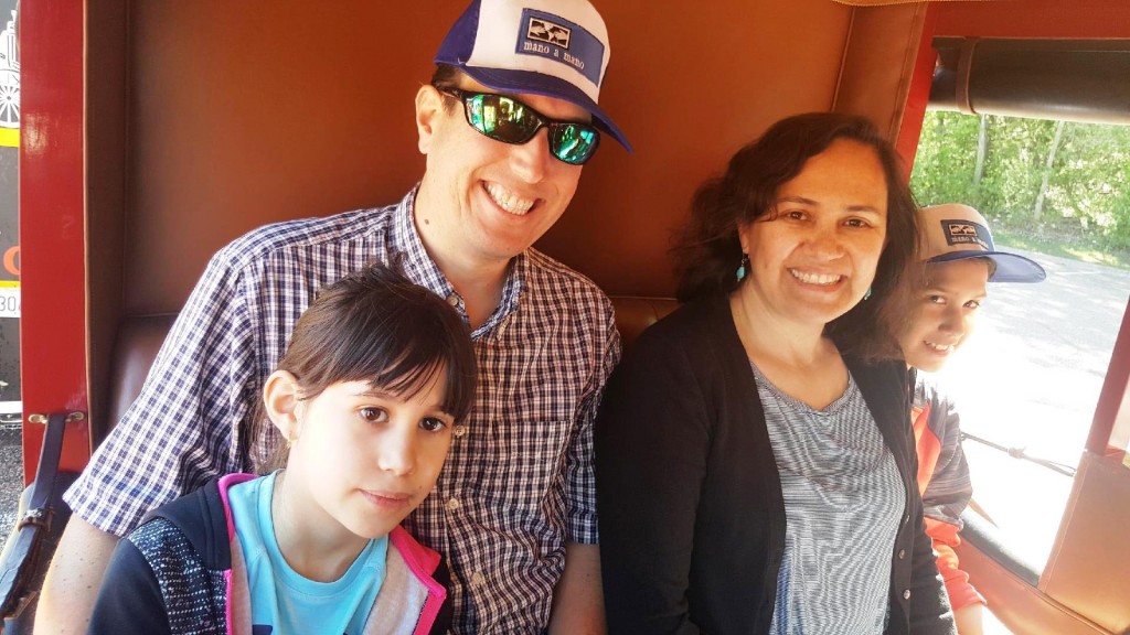 Mano a Mano Operations Manager Carmen Paredes Dockry, with her family, inside the Wells Fargo Stagecoach.