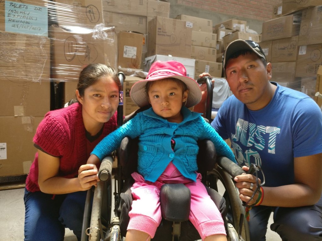 Gabriela, with her parents, in her new wheelchair from Mano a Mano in 2017.